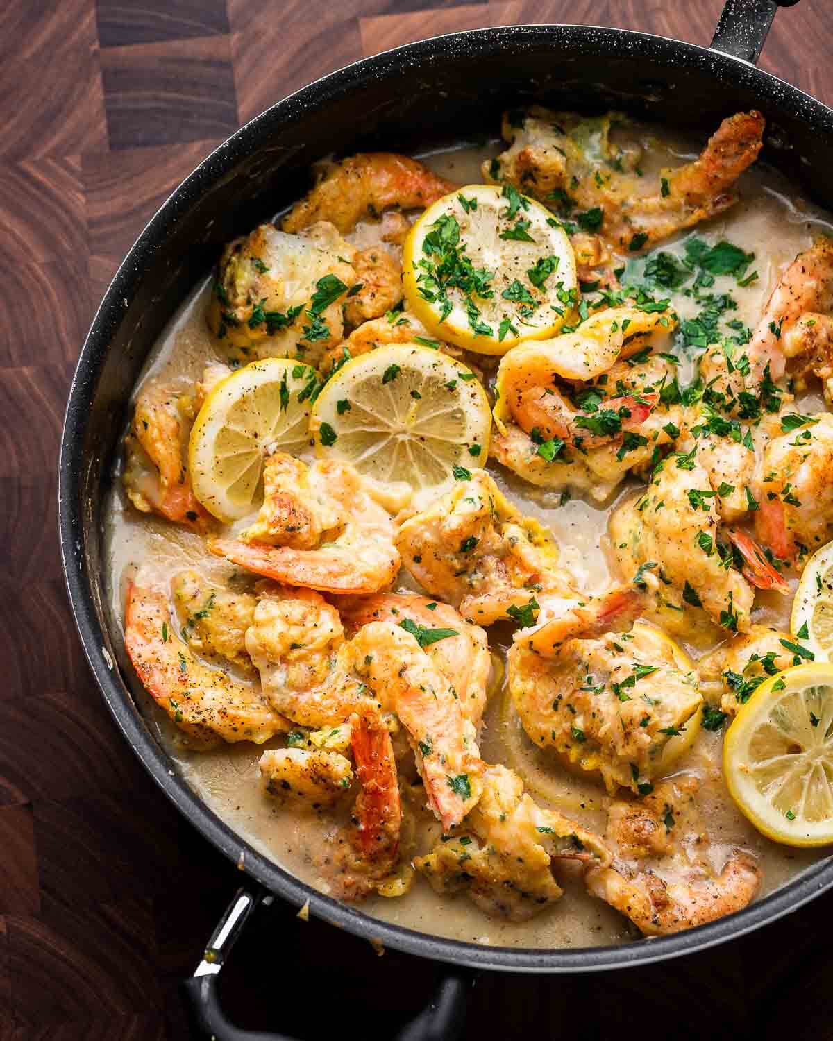 Overhead shot of black pan with shrimp francese.