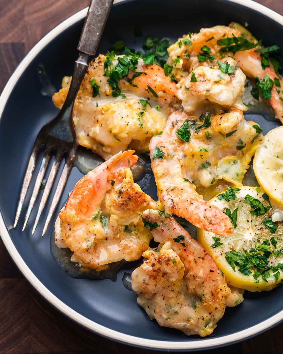 Shrimp francese in blue plate with fork.