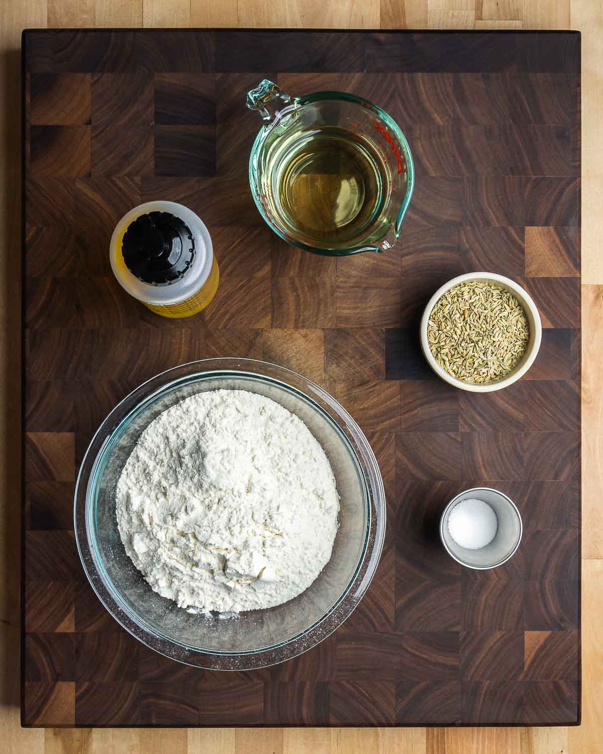 Ingredients shown: olive oil, white wine, fennel seeds, flour, and salt.