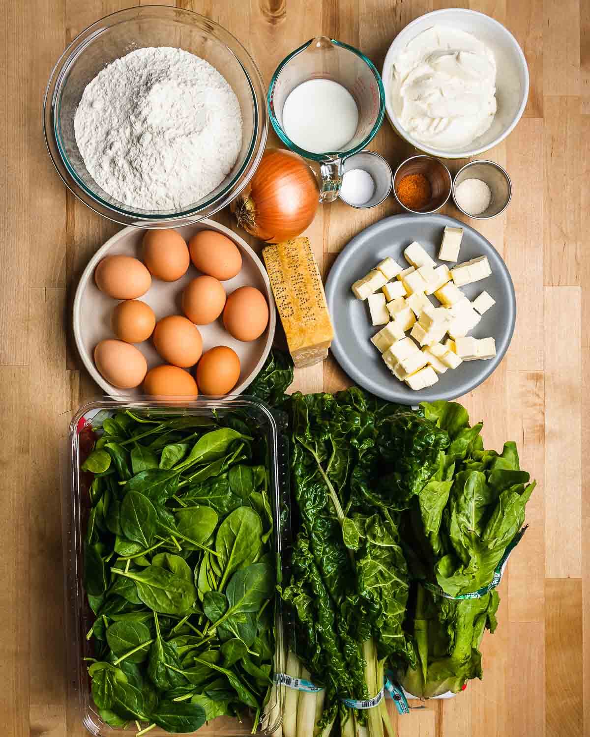 Ingredients shown: flour, milk, ricotta, onion, salt, sugar, nutmeg, eggs, parmesan, butter, spinach, swiss chard, and escarole.