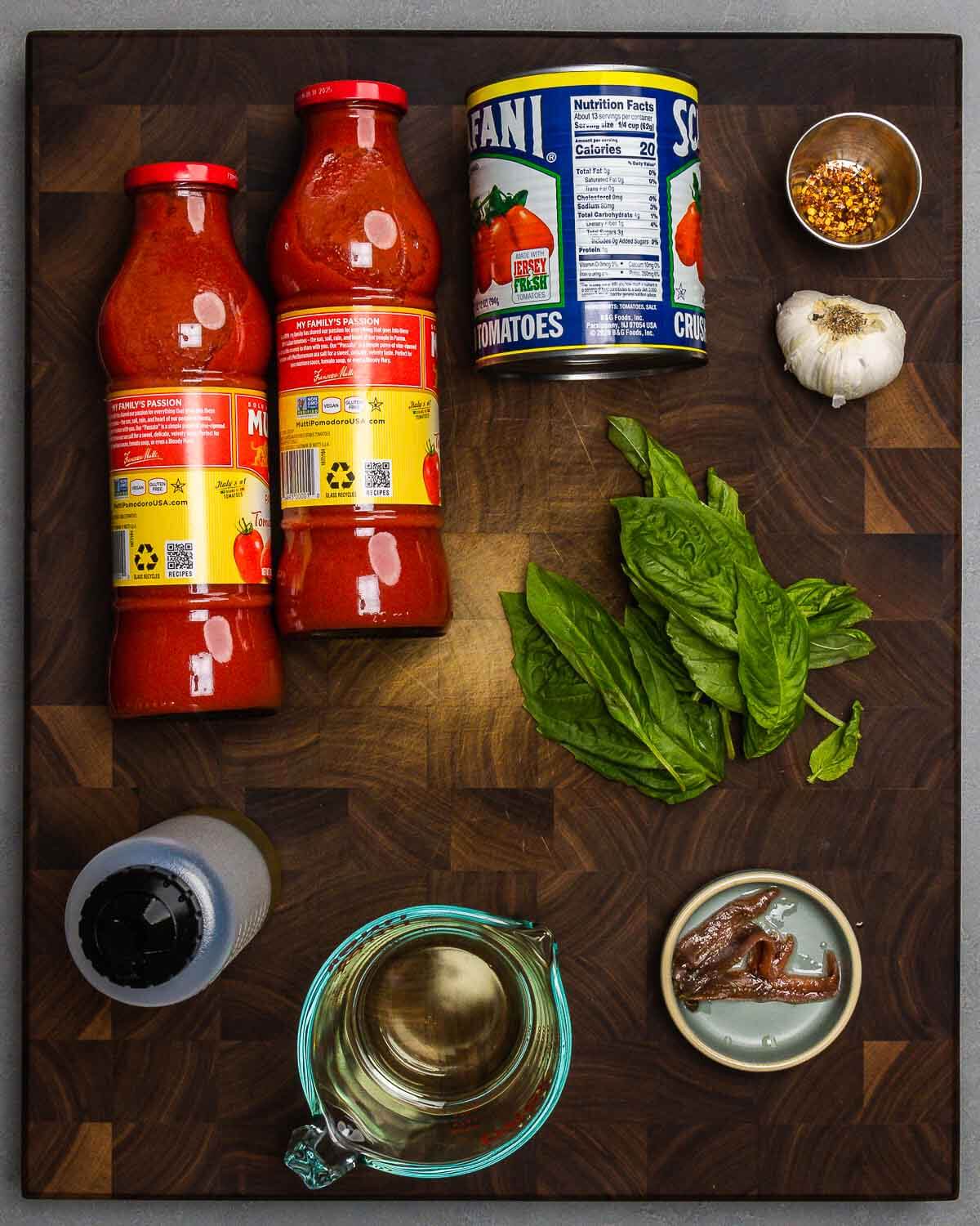 Sauce ingredients shown: passata, crushed tomatoes, garlic, hot red pepper flakes, olive oil, white wine, basil, and anchovies.