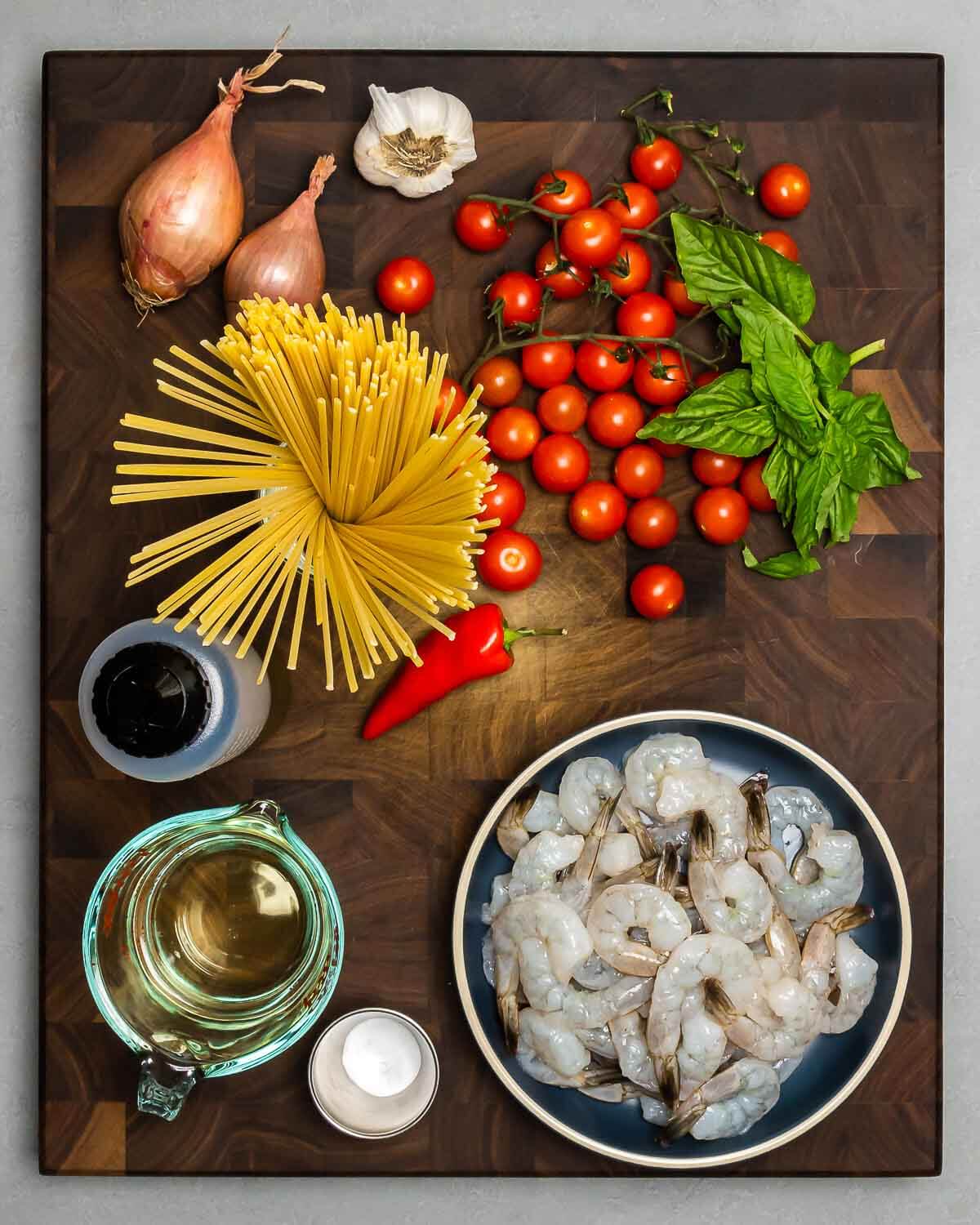 Ingredients shown: shallots, garlic, cherry tomatoes, basil, linguine, chile pepper, olive oil, white wine, baking soda, and shrimp.