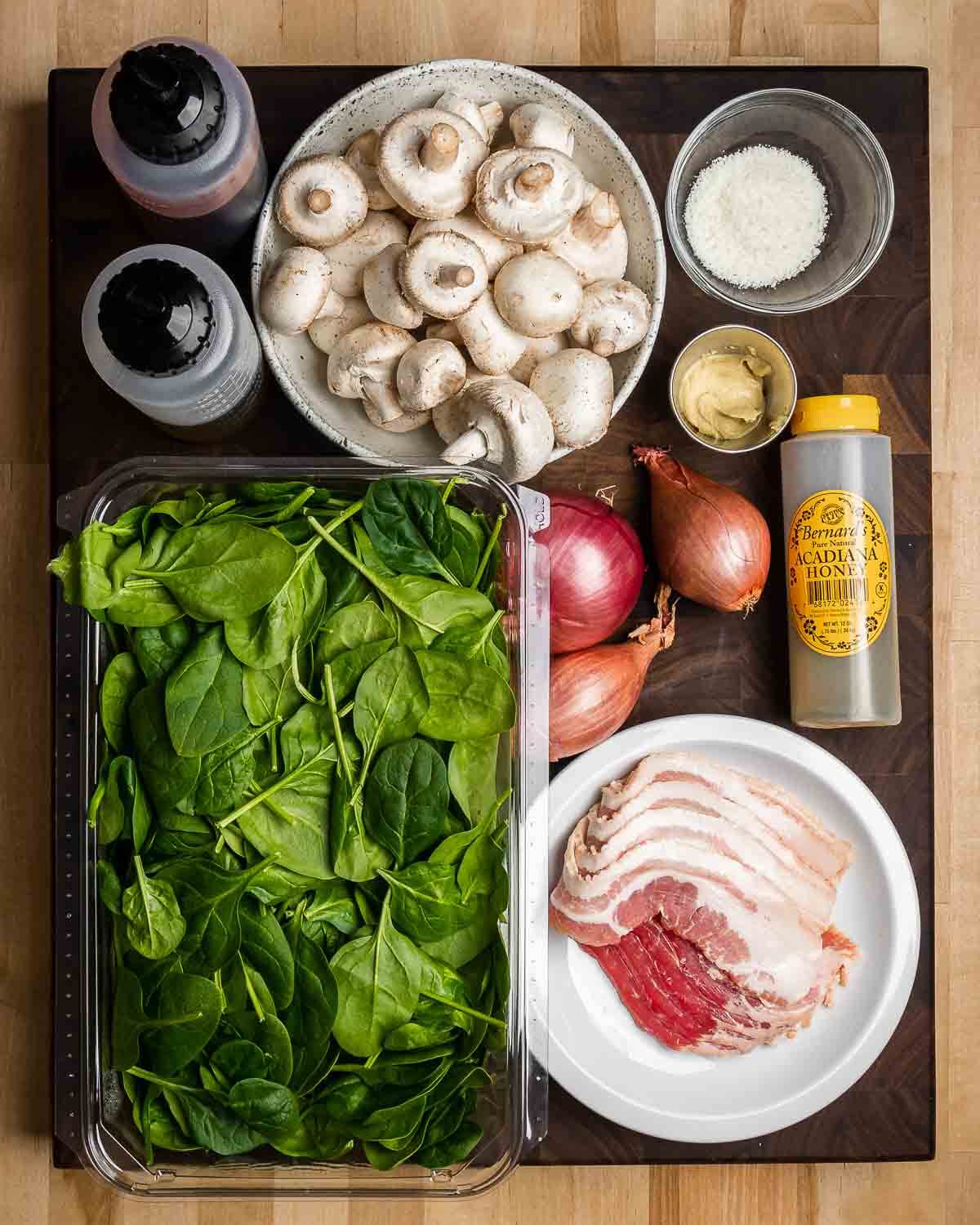 Ingredient shown: red wine vinegar, olive oil, mushrooms, Pecorino Romano, mustard, baby spinach, red onion, shallots, bacon, and honey.