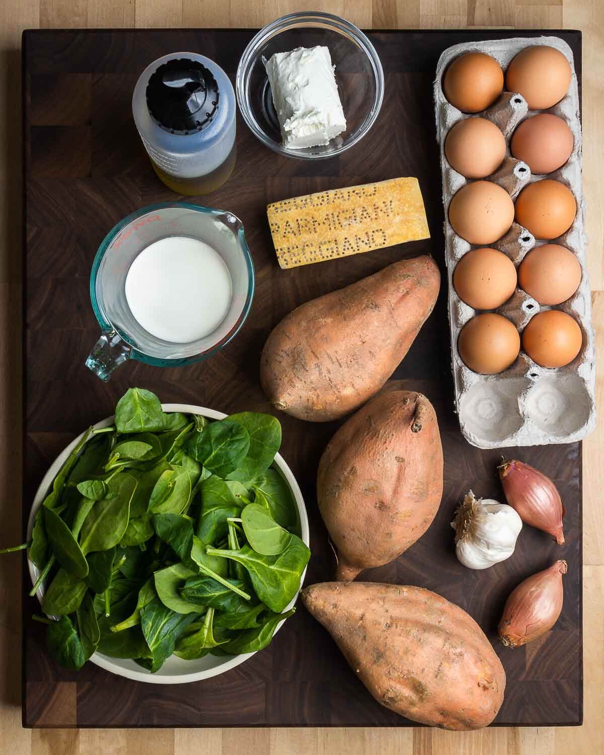 Ingredients shown: olive oil, goat cheese, parmesan, milk, eggs, sweet potatoes, spinach, garlic, and shallots.