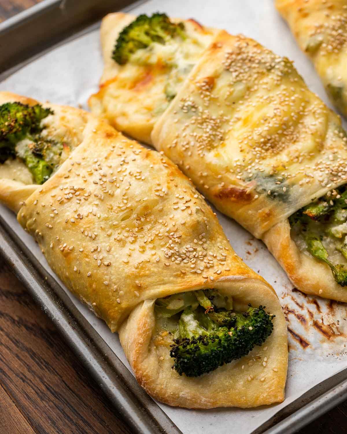 Closeup shot of broccoli rolls in sheet pan.