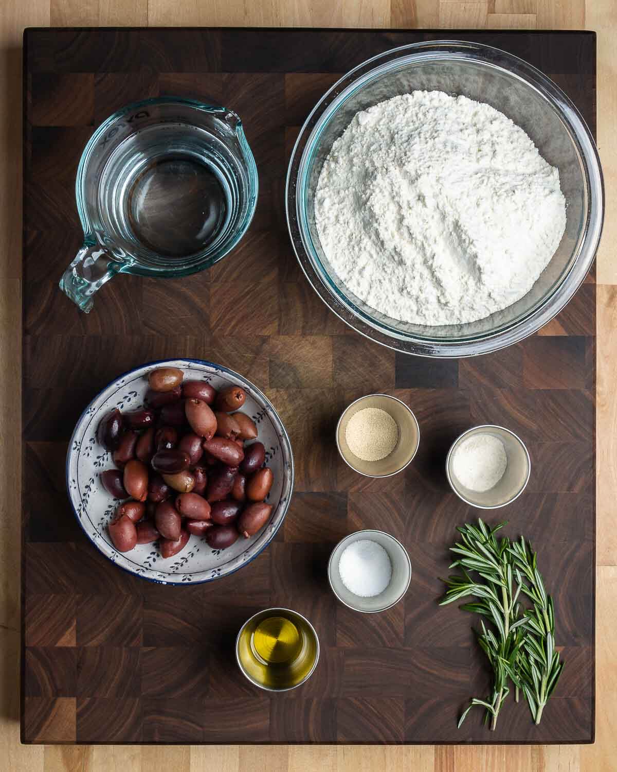 Ingredients shown: water, bread flour, kalamata olives, yeast, diastatic malt powder, salt, olive oil, and rosemary.