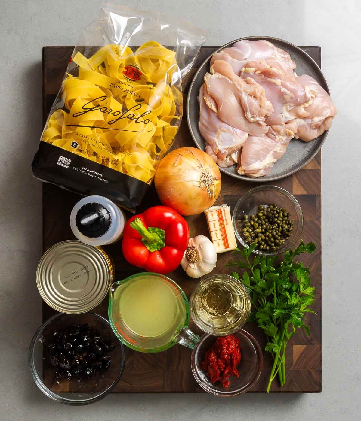 Ingredients shown: pappardelle, chicken thighs, onion, olive oil, bell pepper, garlic, butter, capers, tomatoes, chicken stock, olives, white wine, tomato paste, and parsley.