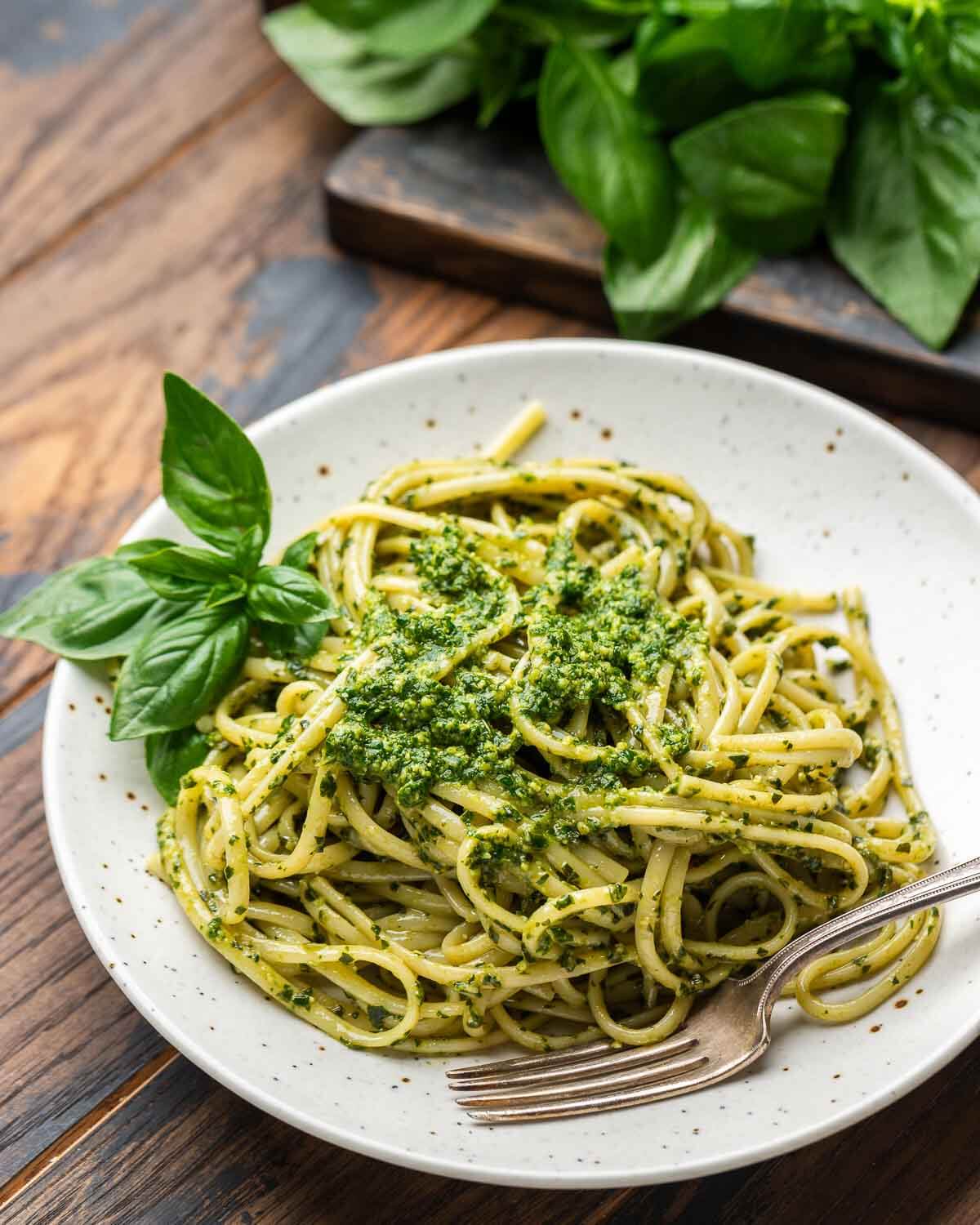 Pesto alla Genovese with linguine in white plate.