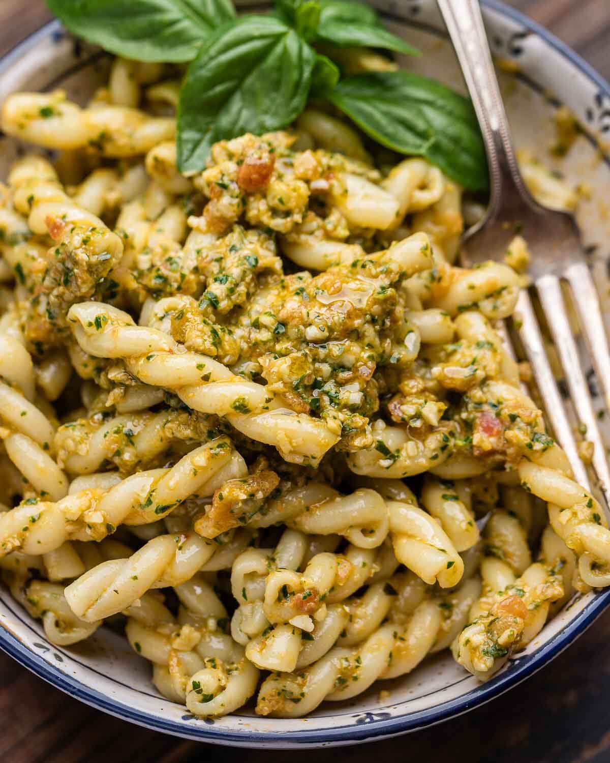 Overhead shot of small bowl of pasta with pesto alla Trapanese.