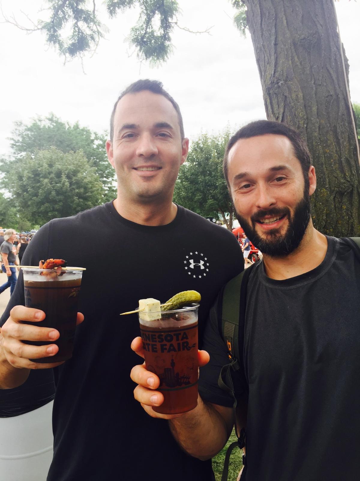 Minnesota state fair pic with my brother and I holding beers with pickle and bacon.