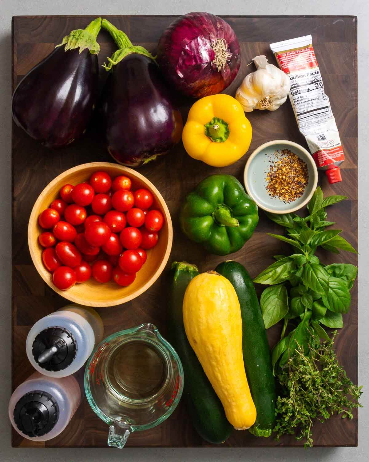 Ingredients shown: eggplant, red onion, garlic, tomato paste, bell peppers, hot red pepper flakes, tomatoes, squash, zucchini, olive oil, vinegar, white wine, basil, and thyme.