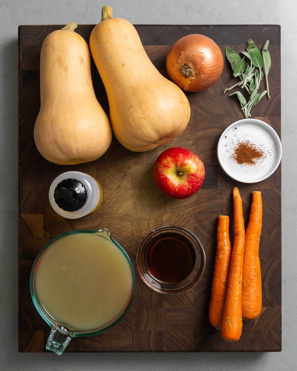 Ingredients shown: butternuts quash, onion, sage, olive oil, apple, nutmeg, vegetable stock, maple syrup, and carrots.