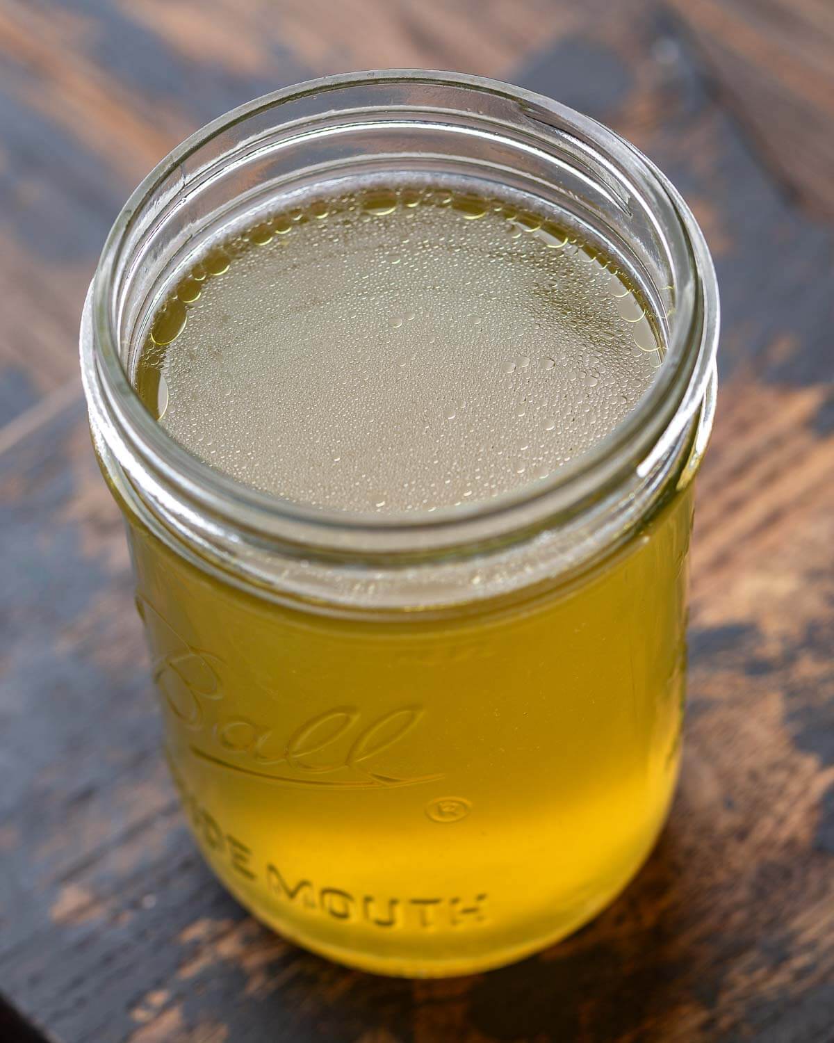 Mason jar filled with chicken stock.