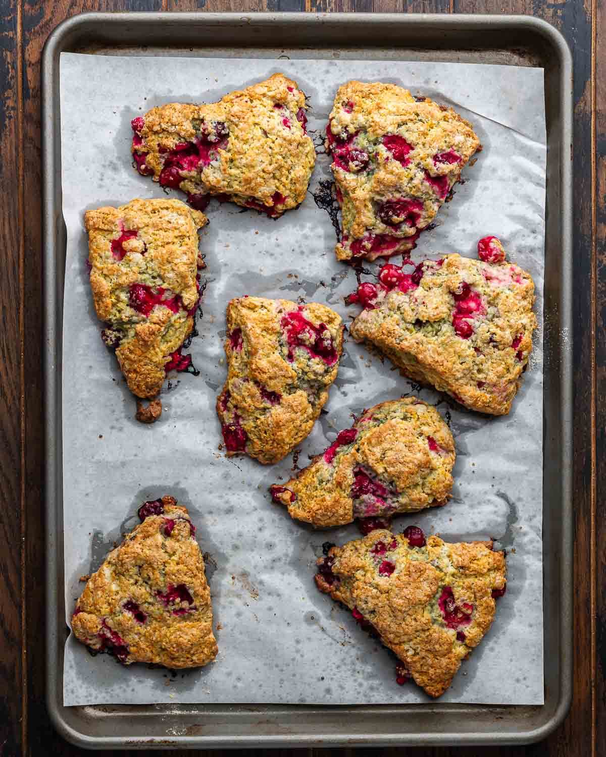 Cranberry orange scones on baking sheet.