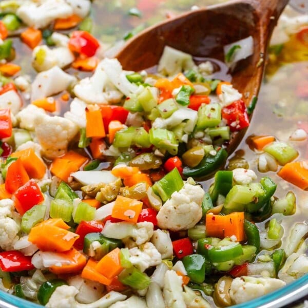 Featured image showing bowl of giardiniera with wooden ladle.