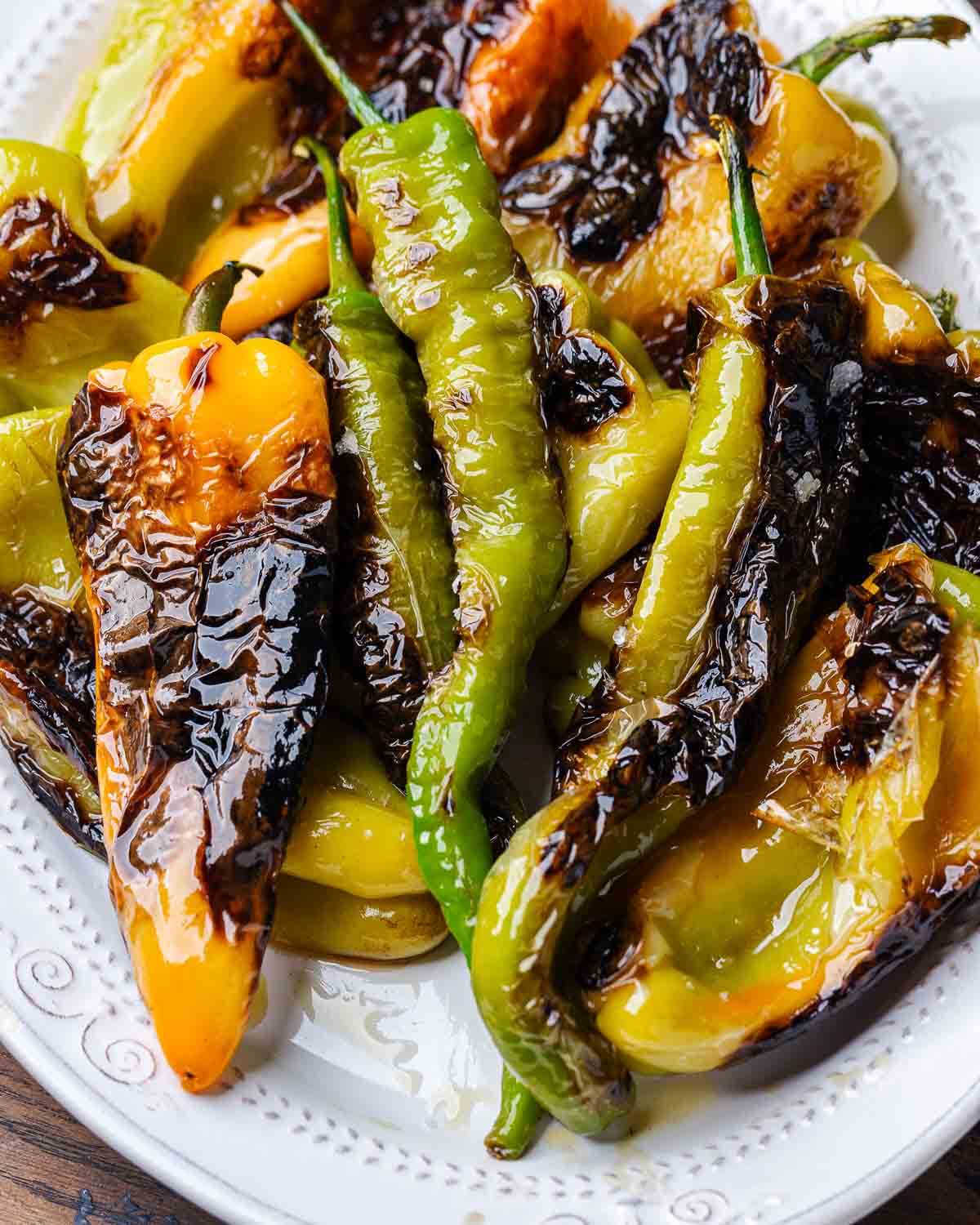 Assorted Italian fried peppers in large white platter.