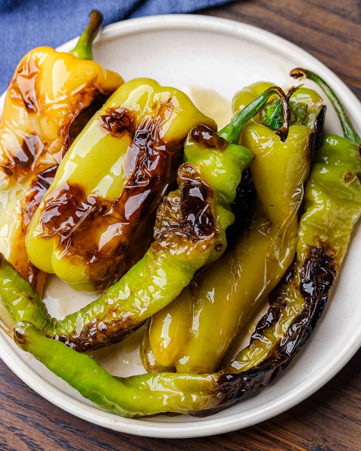 Assorted Italian fried peppers in white plate.