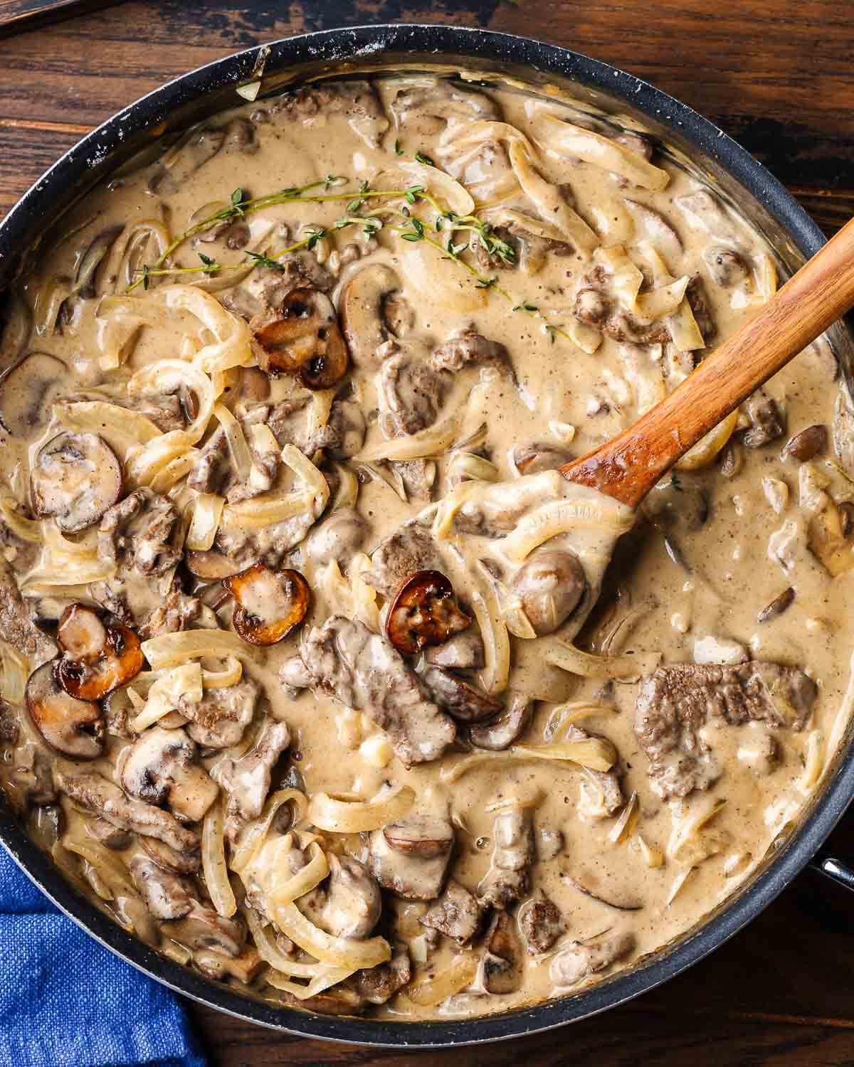 Overhead shot of black pan with beef stroganoff.