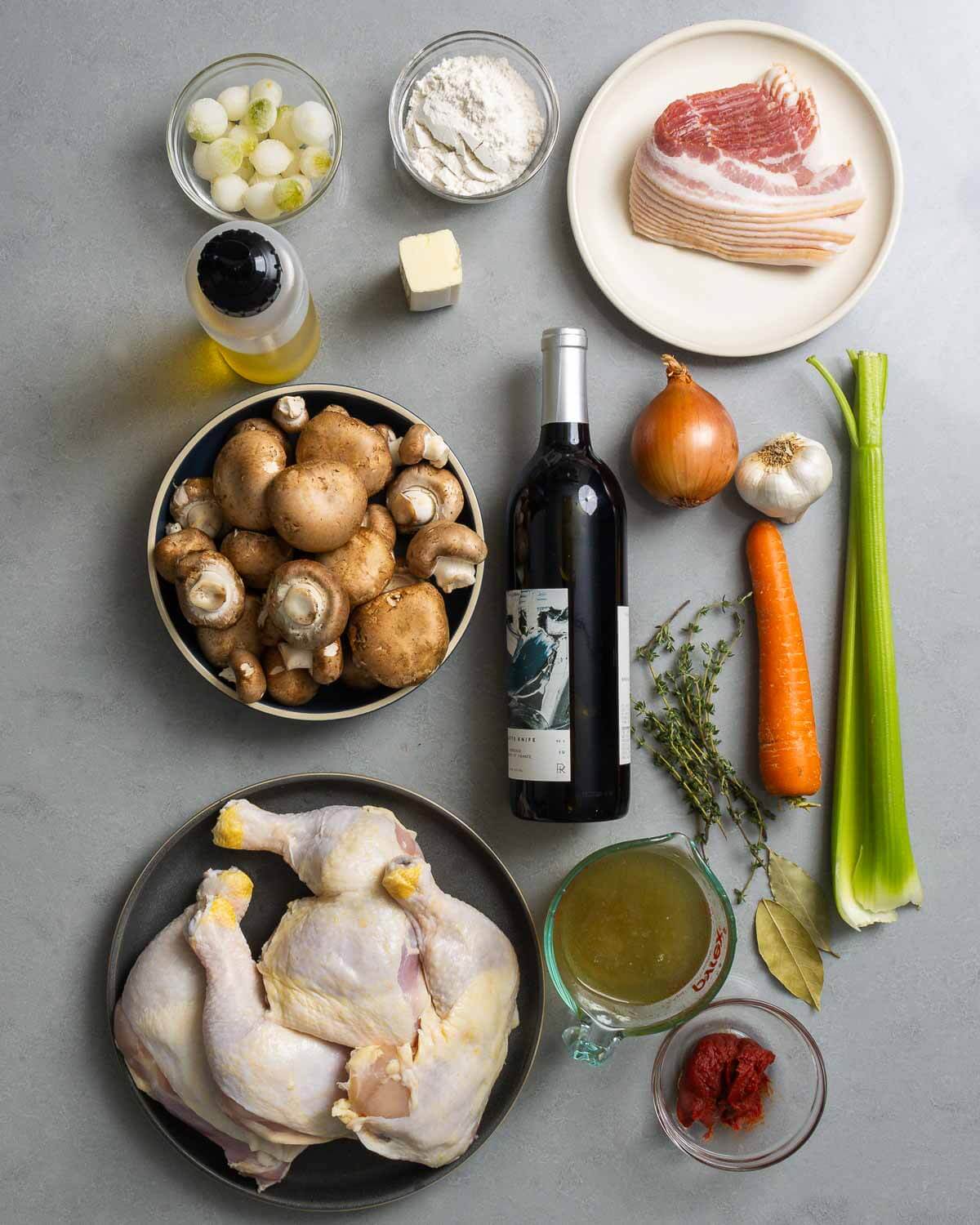 Ingredients shown: pearl onions, olive oil, flour, butter, bacon, mushrooms, red wine, vegetables, chicken, chicken stock, tomato paste, and herbs.