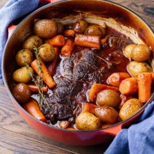 Featurd image showing pot roast with vegetables in Dutch oven.