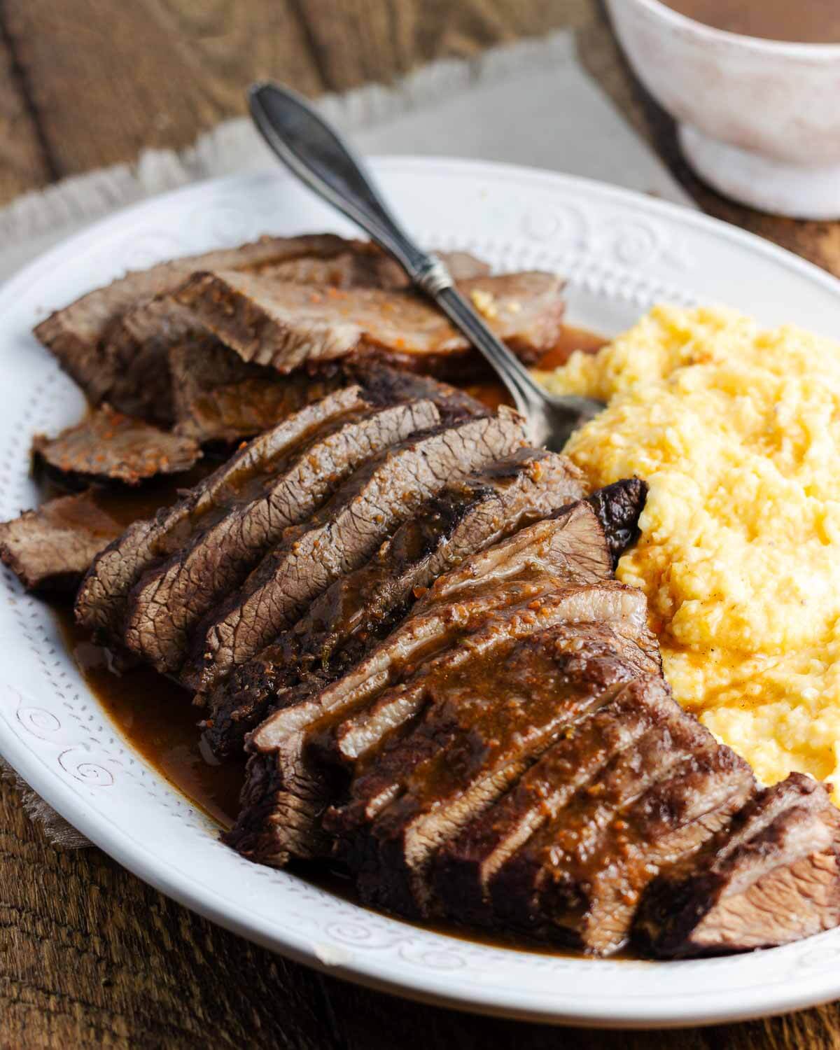 Brasato al Barolo in white platter with polenta.