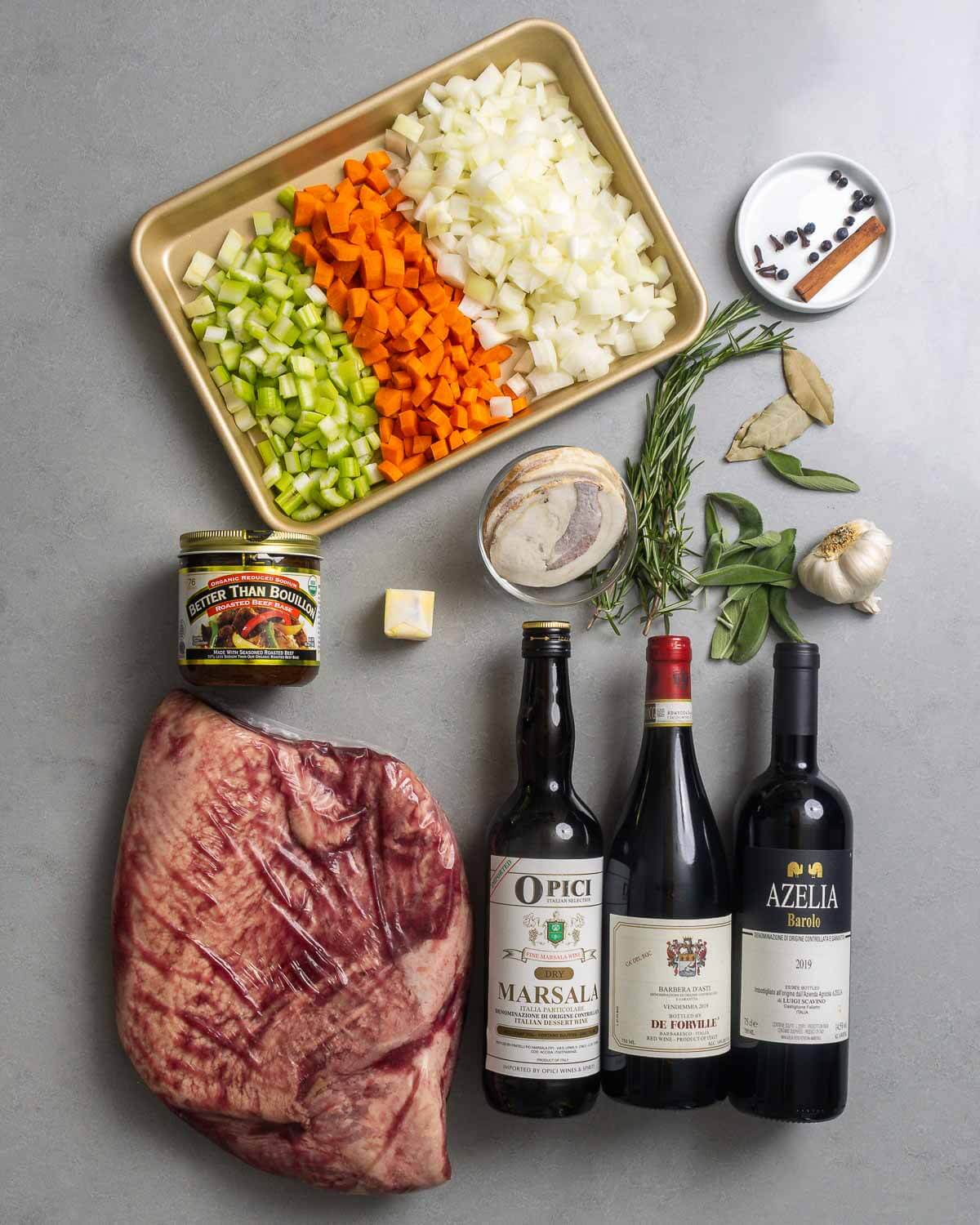 Ingredients shown: celery, carrots, onions, cinnamon, cloves, juniper berries, bay leaves, rosemary, sage, garlic, pancetta, butter, beef stock, brisket, and barbera, barolo, and marsala wines.