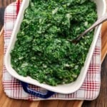 Creamed spinach in platter on top of red and white heat pad.