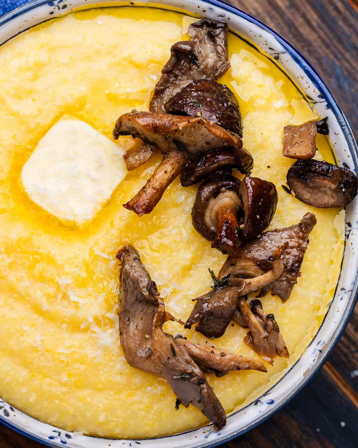 Roasted mushrooms atop bowl of polenta.