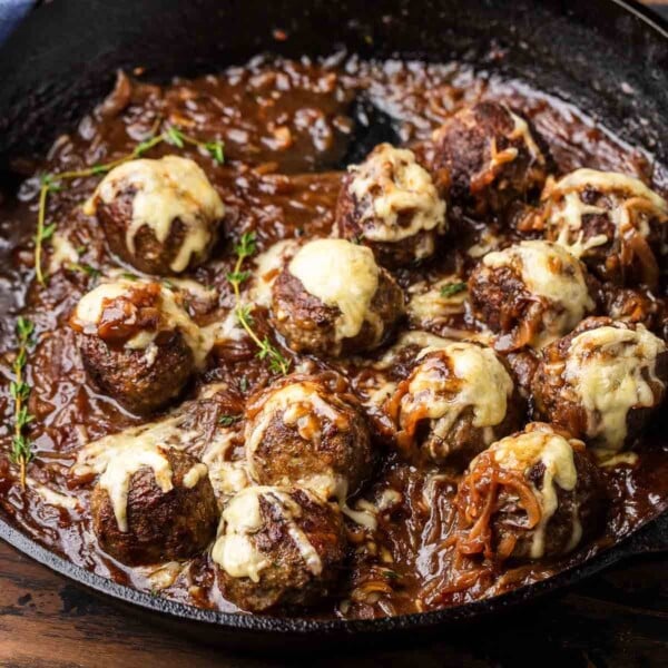 French onion meatballs in black cast iron pan featured image.