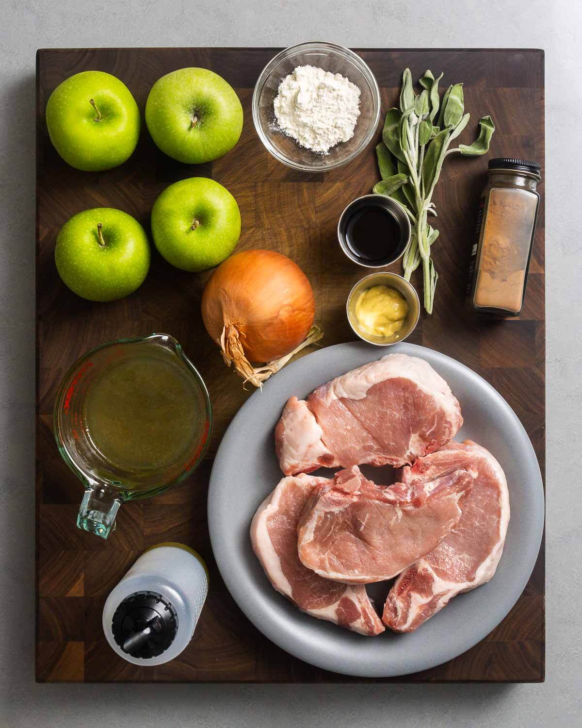 Ingredients shown: apples, flour, sage, balsamic vinegar, cinnamon, Dijon, onion, chicken stock, pork chops, and olive oil.