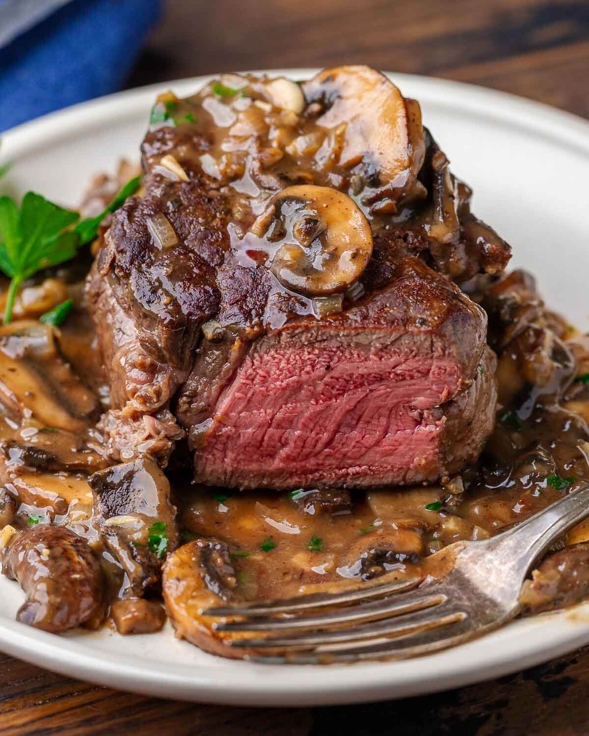 One large filet mignon cut into with mushroom sauce.
