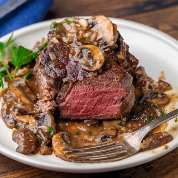 Beef marsala featured image in white plate with fork.