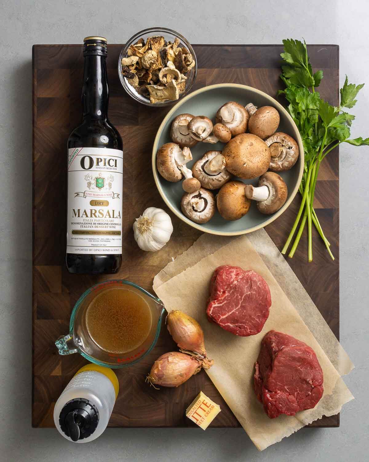 Ingredients shown: marsala wine, mushrooms, parsley, garlic, beef stock, olive oil, shallots, butter, and filet mignon.