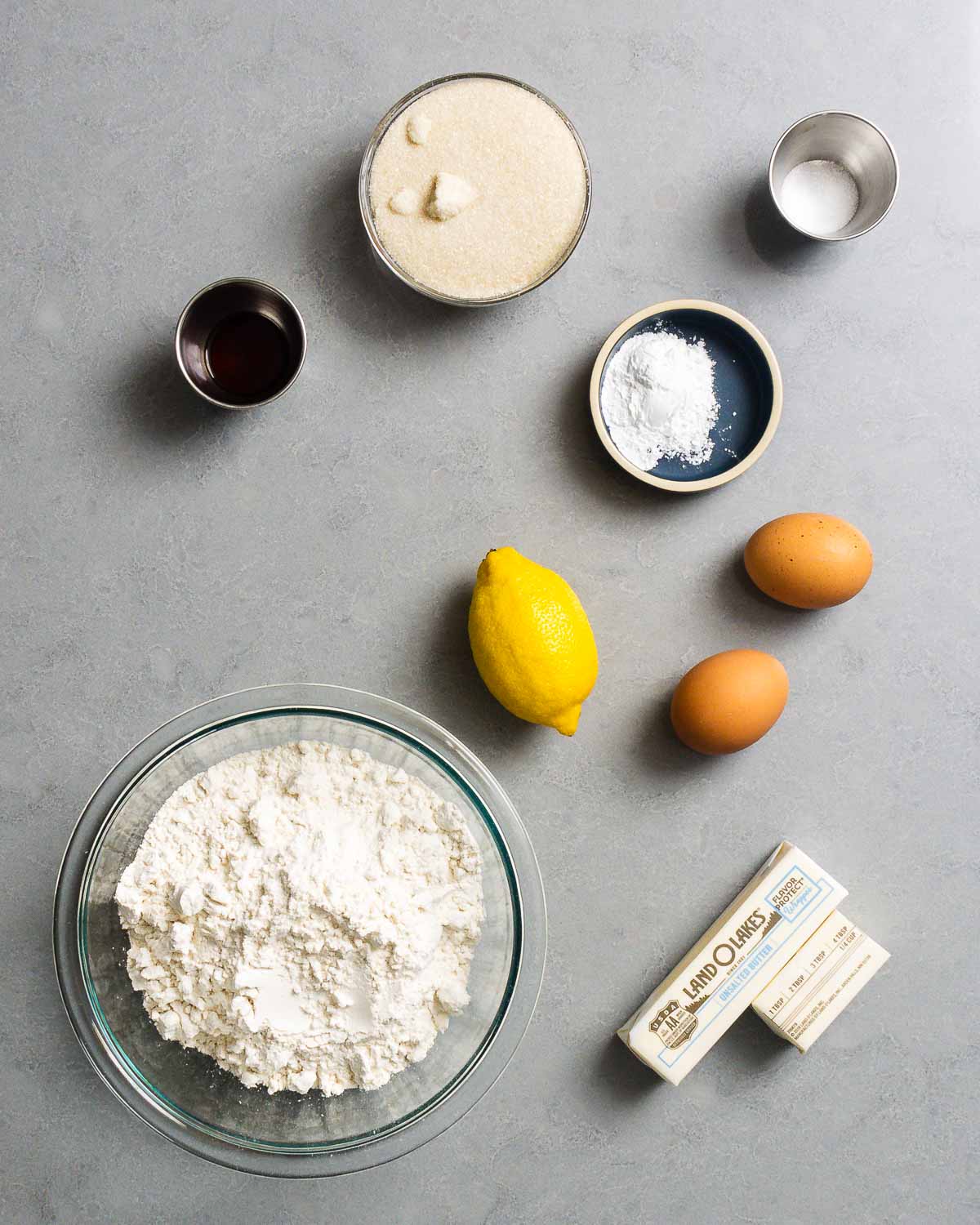 Ingredients shown: vanilla, sugar, salt, baking powder, lemon, eggs, flour, and butter.