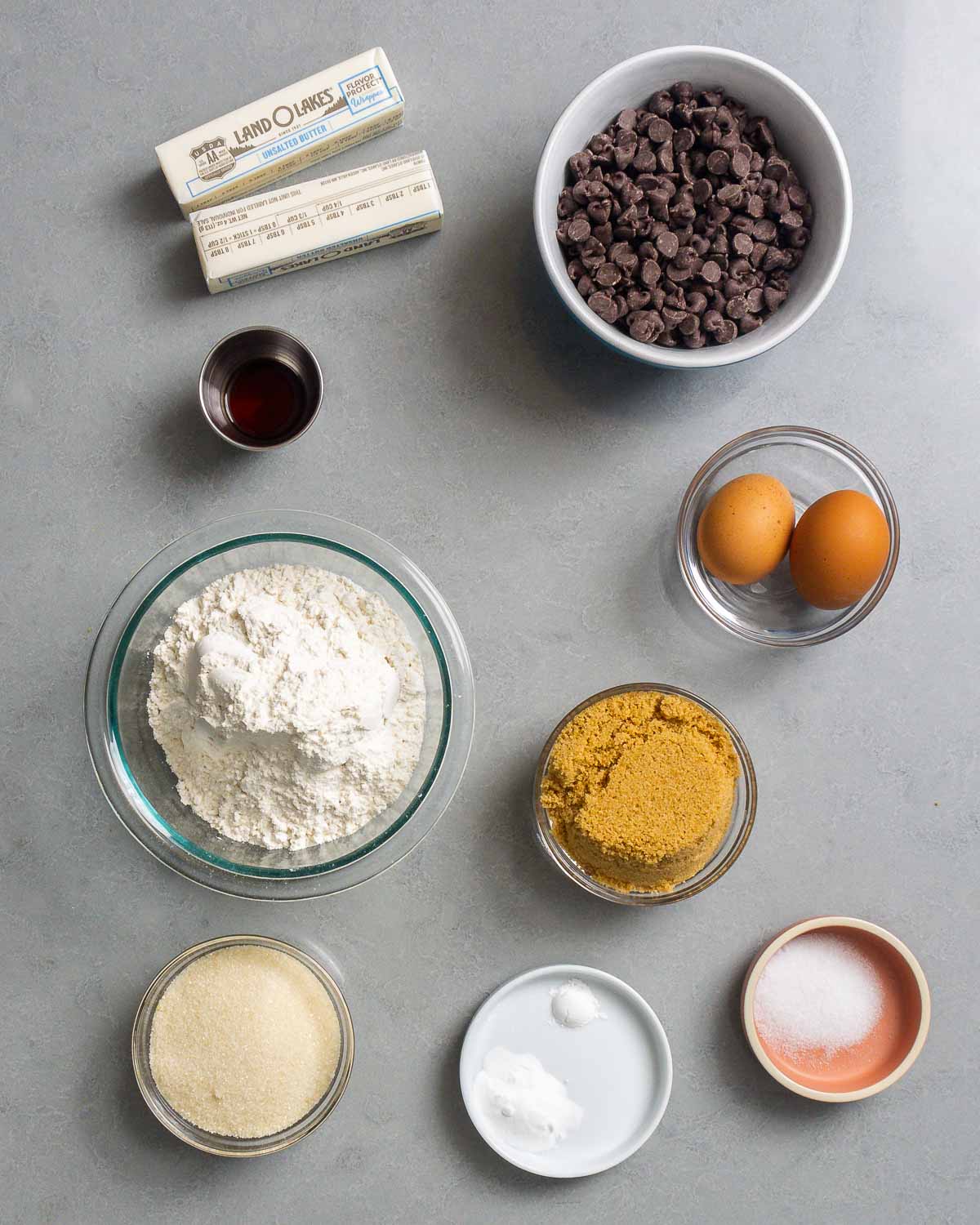 Ingredients shown: butter, chocolate chips, vanilla, eggs, flour, brown sugar, sugar, baking soda and powder, and salt.