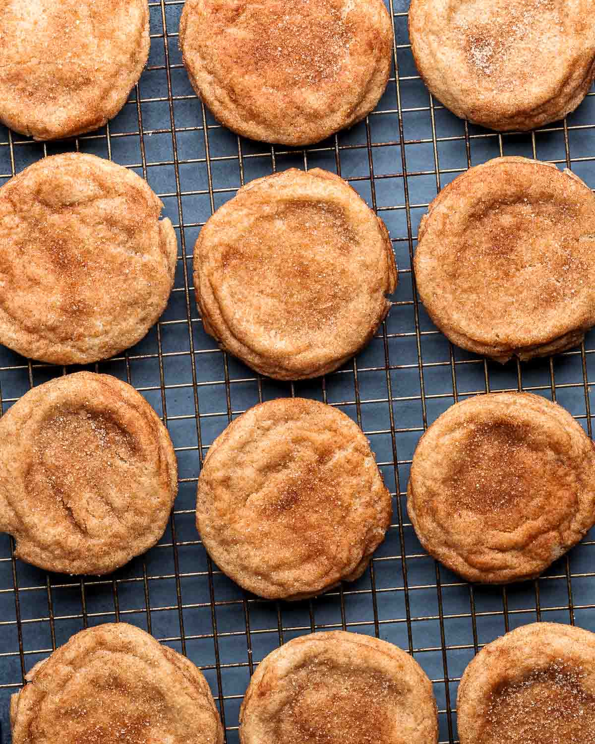 Many snickerdoodle cookies on wire rack.