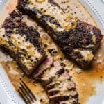 Steak au poivre in white platter for Pinterest image.