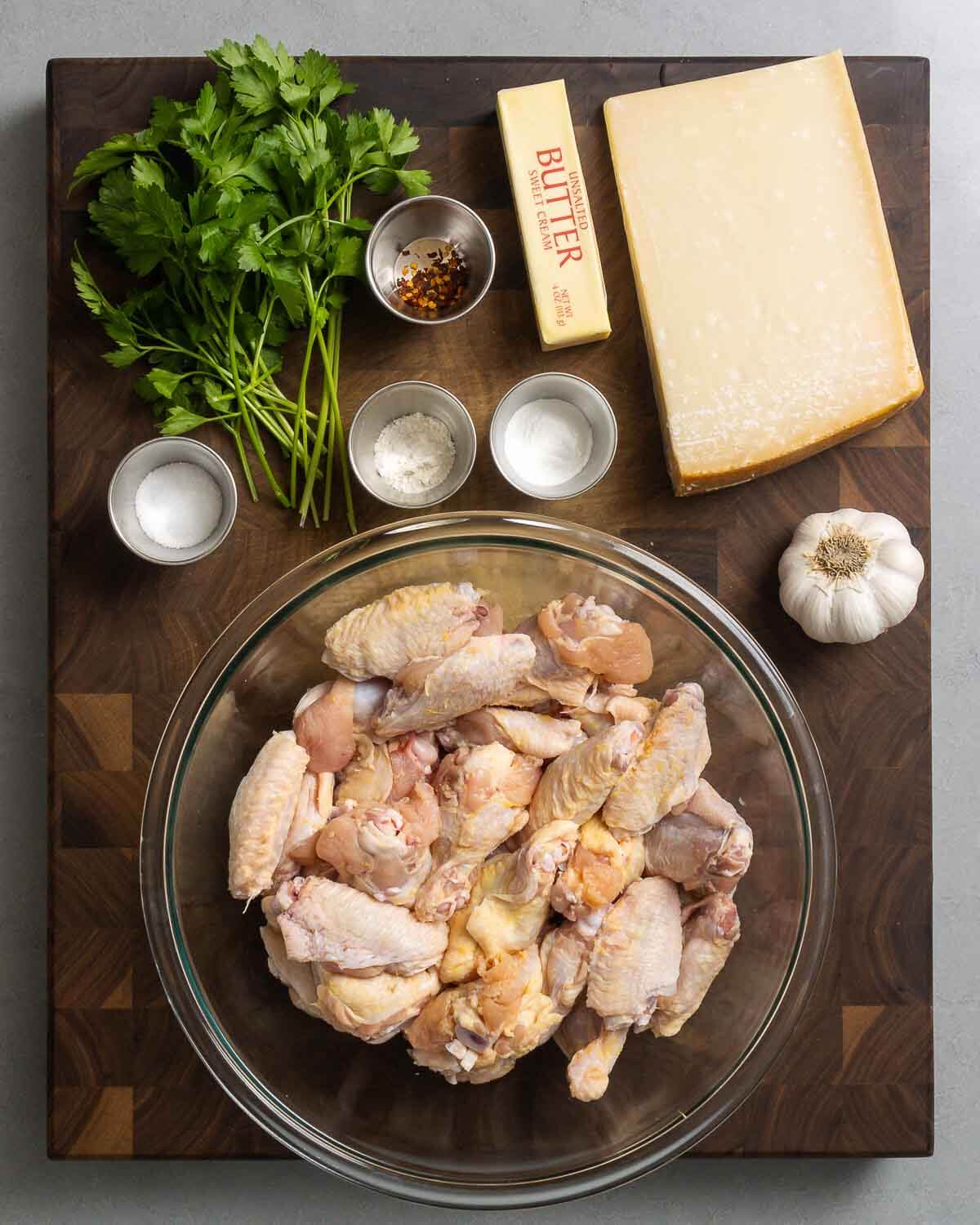 Ingredients shown: parsley, salt, flour, baking powder, butter, parmesan cheese, garlic, and party wings.