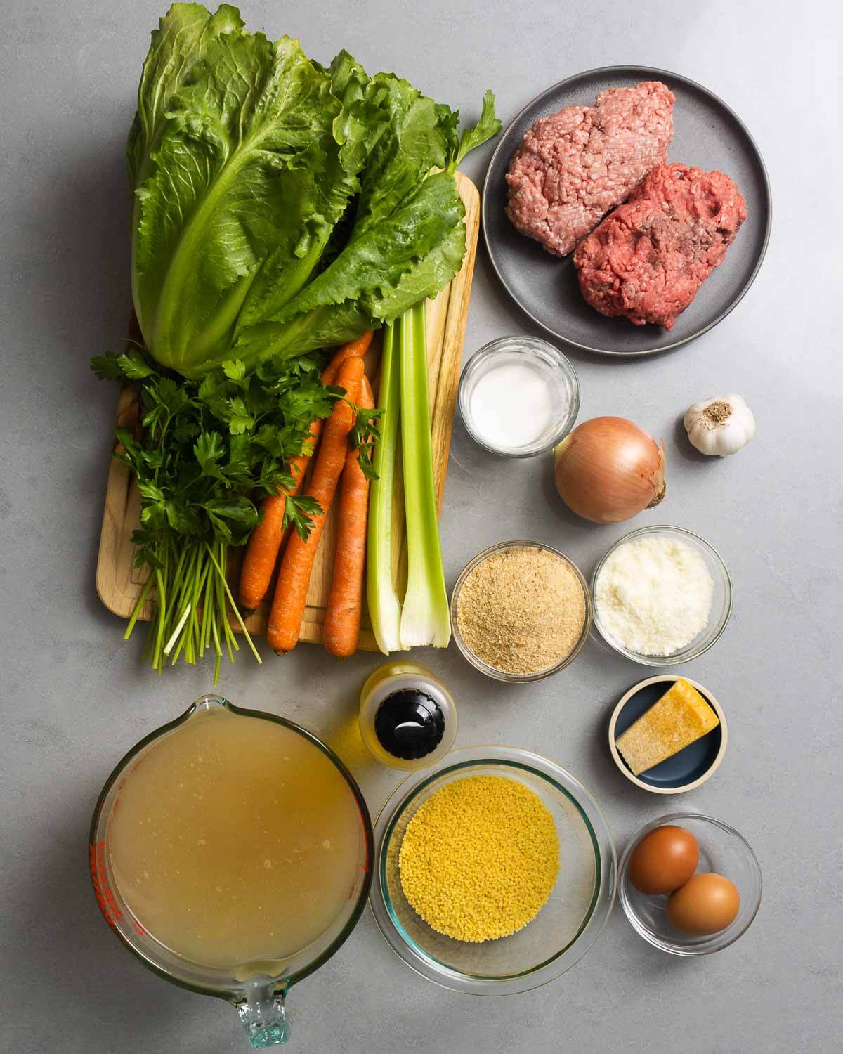 Ingredients shown: escarole, parsley, carrots, celery, ground beef and pork, milk, onion, garlic, breadcrumbs, pecorino, parmesan rind, olive oil, chicken stock, acini di pepe, and eggs.