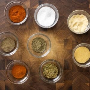 Cajun seasoning featured image with bowls of spices on cutting board.