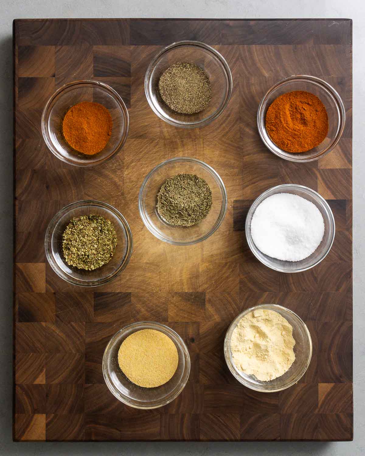 Ingredients shown: Paprika, Diamond crystal kosher salt, onion, powder, granulated garlic, dried oregano, dried thyme, black pepper, and cayenne.