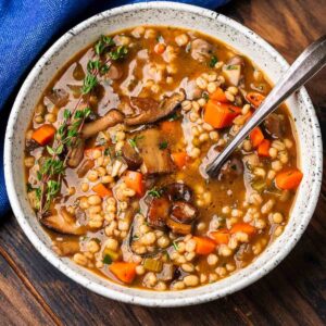 White bowl of mushroom barley soup for featured image.