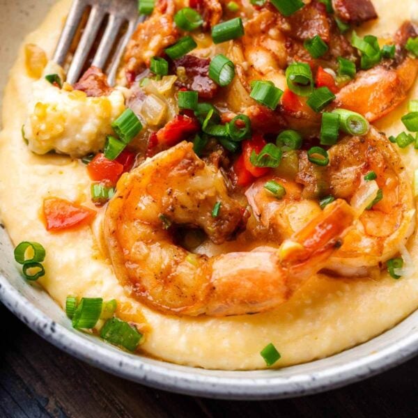 Shrimp and grits in white bowl for featured image.