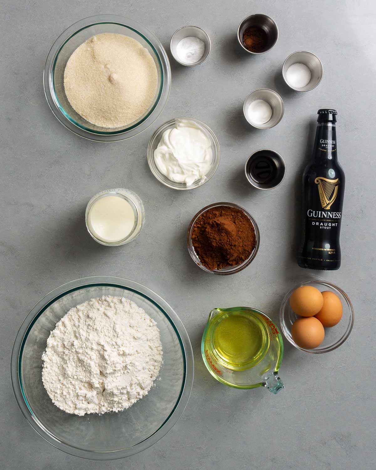 Ingredients shown: sugar, sour cream salt, baking powder, baking soda, espresso powder, vanilla, cocoa powder, Guinness, buttermilk, eggs, vegetable oil, and flour.