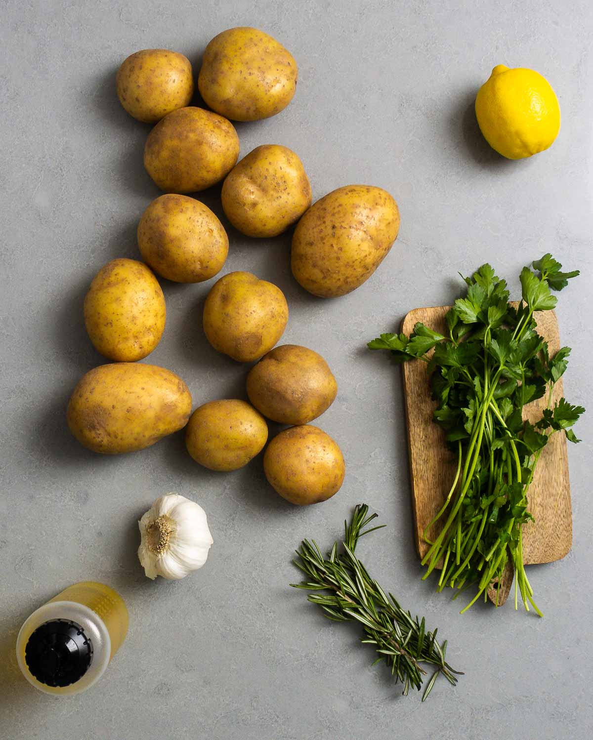 Ingredients shown: Yukon Gold potatoes, lemon, garlic, olive oil, Rosemary, and parsley.