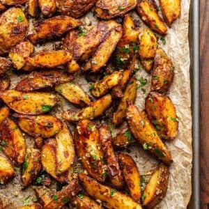 Cripsy roasted potatoes on brown parchment paper for featured image.