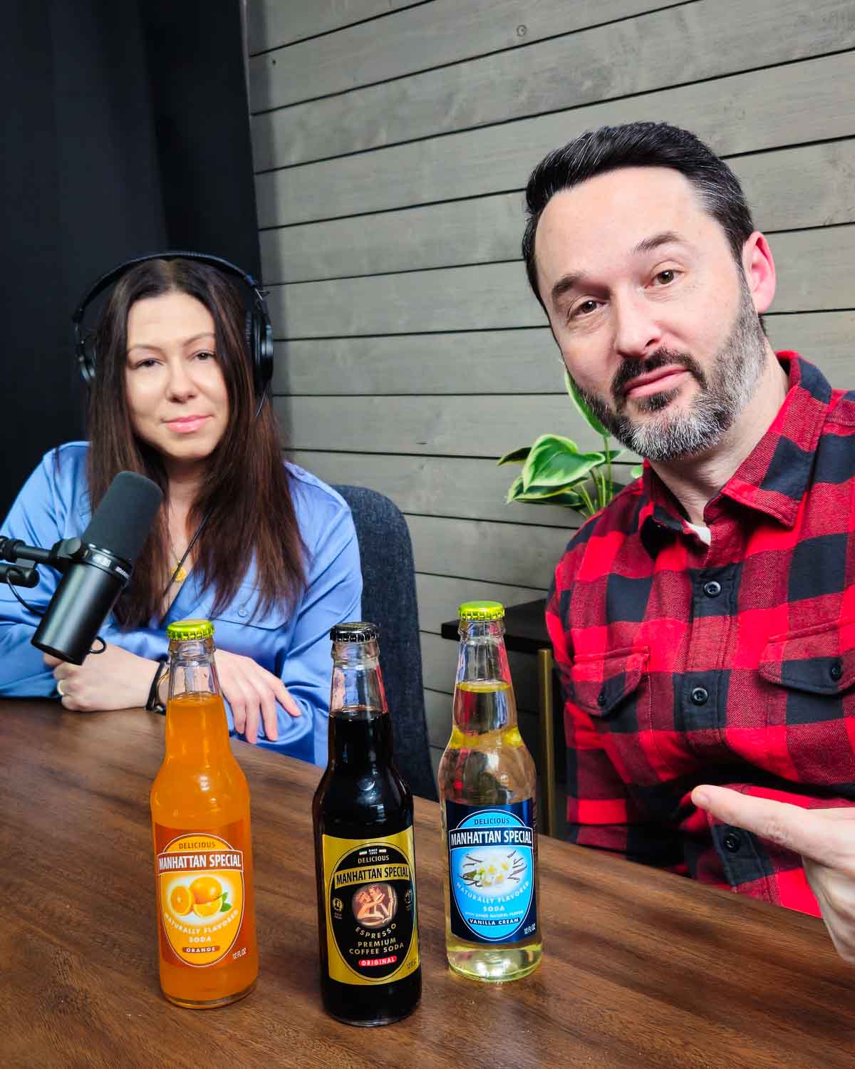 Jim and Tara in Podcast studio with 3 Manhattan Special sodas on table.