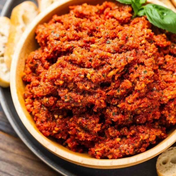 Sun dried tomato tapenade in wood bowl for featured image.