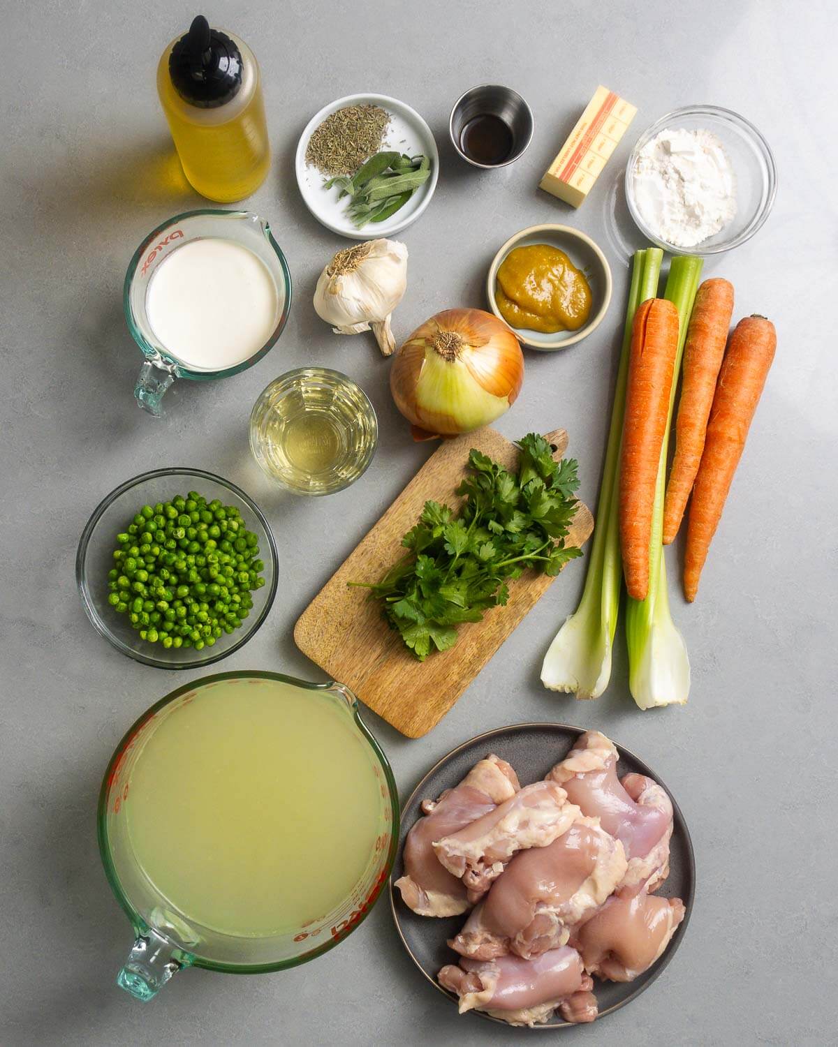 Soup ingredients shown: olive oil, herbs, worcestershire sauce, butter, flour, cream, garlic, chicken base, onion, wine, celery, carrots, peas, chicken stock, and chicken thighs.
