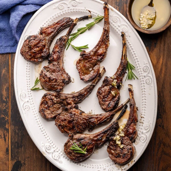Grilled lamb rib chops on white platter for featured image.